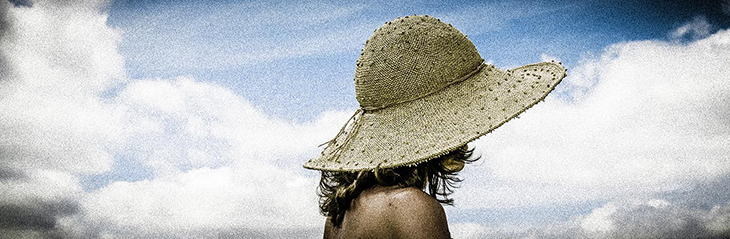 Penelope at Sparsholt, Lady in wide brimmed straw hat with sky background
